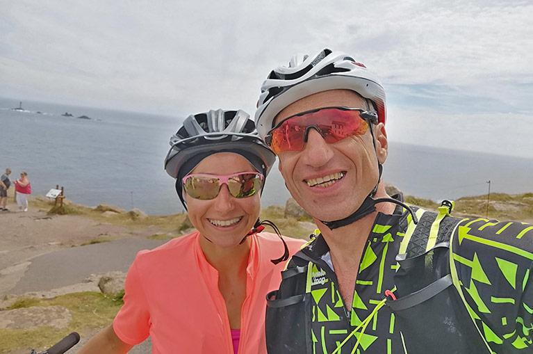 Cyclists stop at Land's End on a Cornwall Cycling Holiday